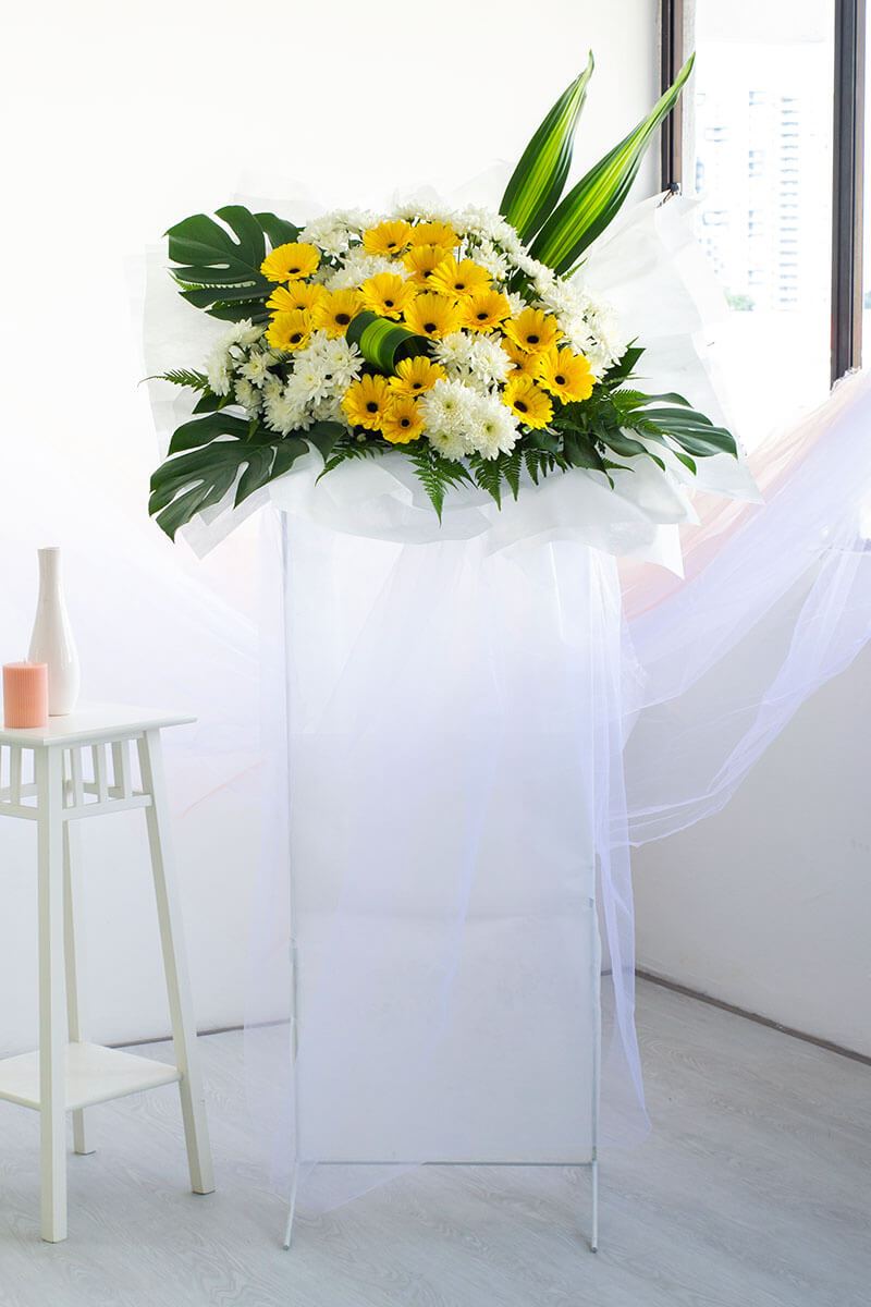 Tanvi Yellow Gerbera Condolence Flower Stand