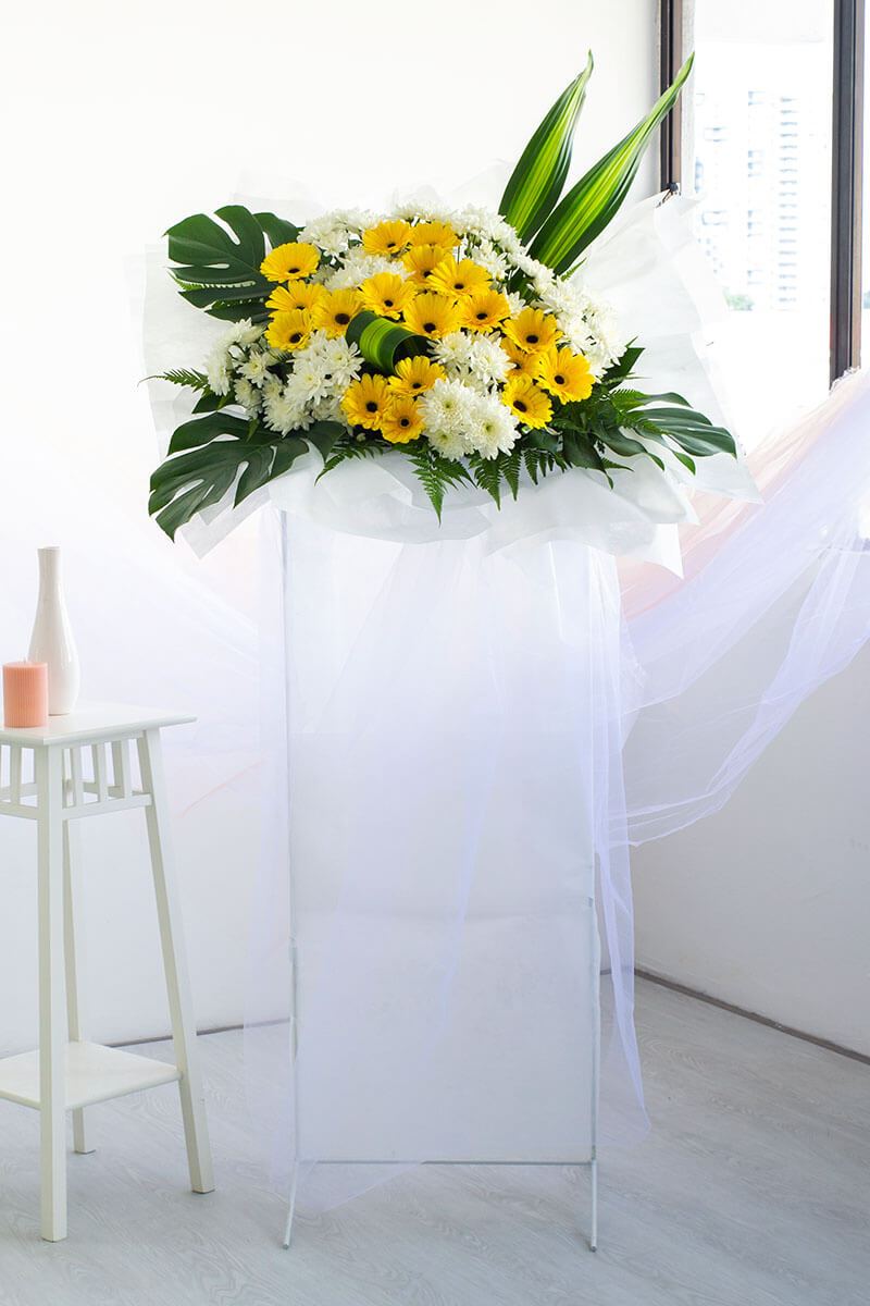 Tanvi Yellow Gerbera Condolence Flower Stand | Free Delivery | Bloomthis